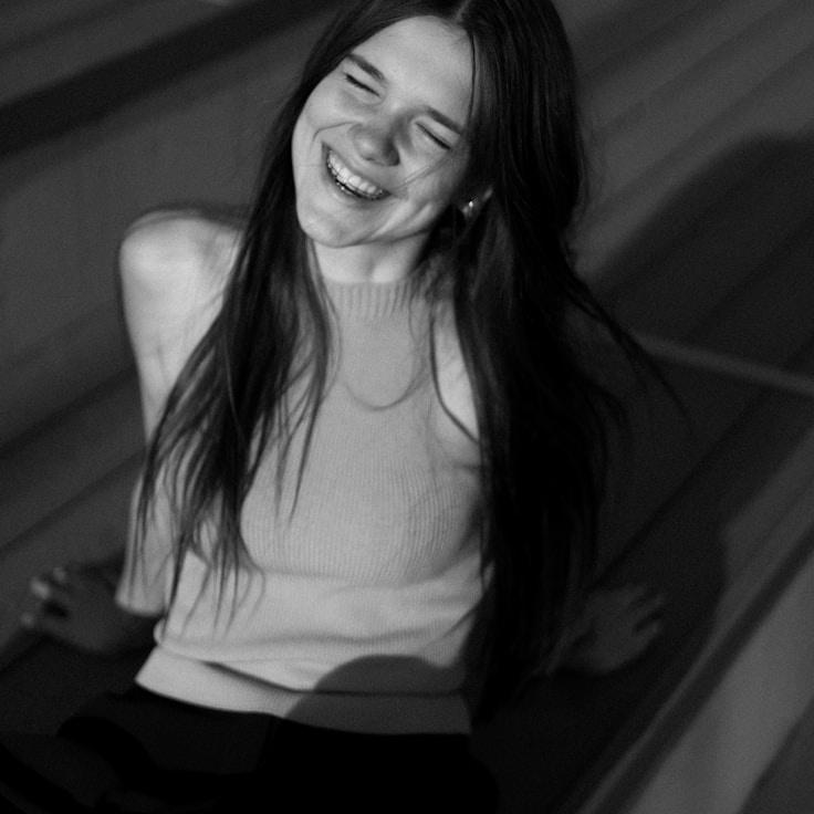 Amina Rao, Lead Design Curator at SageHarborPro, reviewing corporate floral arrangements